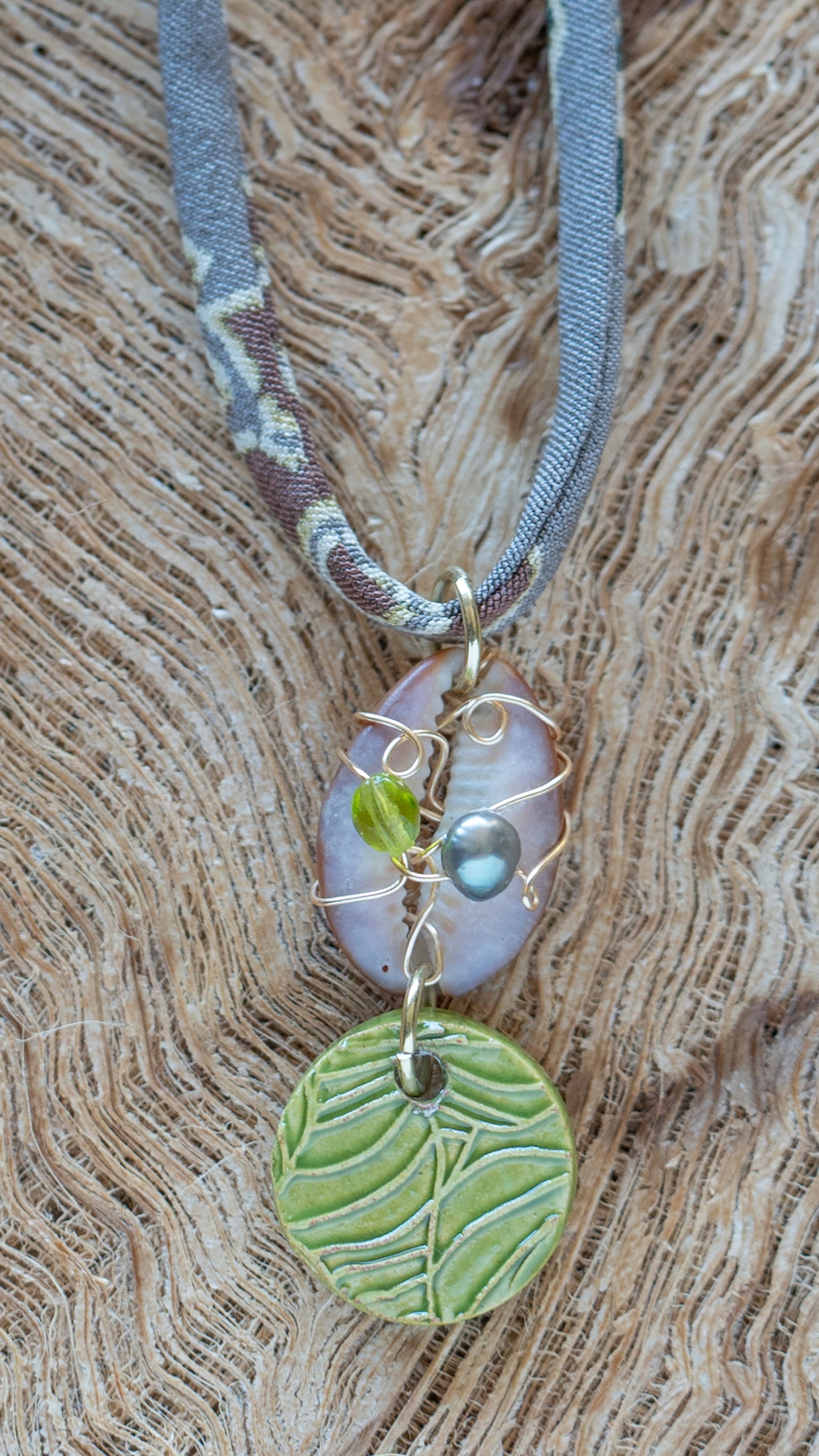 NKL-MON03GRN: Green Monstera Leaf Ceramic Necklace with Wire wrapped Cowrie Shell and Adjustable Floral Kimono Cord – Green Glaze