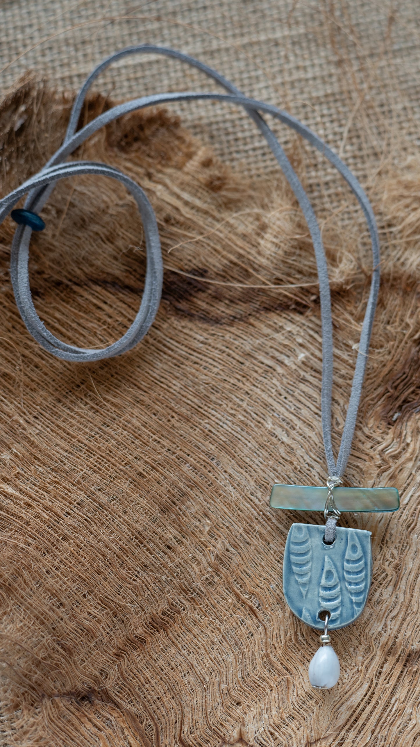 NKL-FSH02BLU: Fishes Ceramic Necklace with Natural Abalone and Jobs Tears and Faux Suede Grey Cord – Blue Glaze