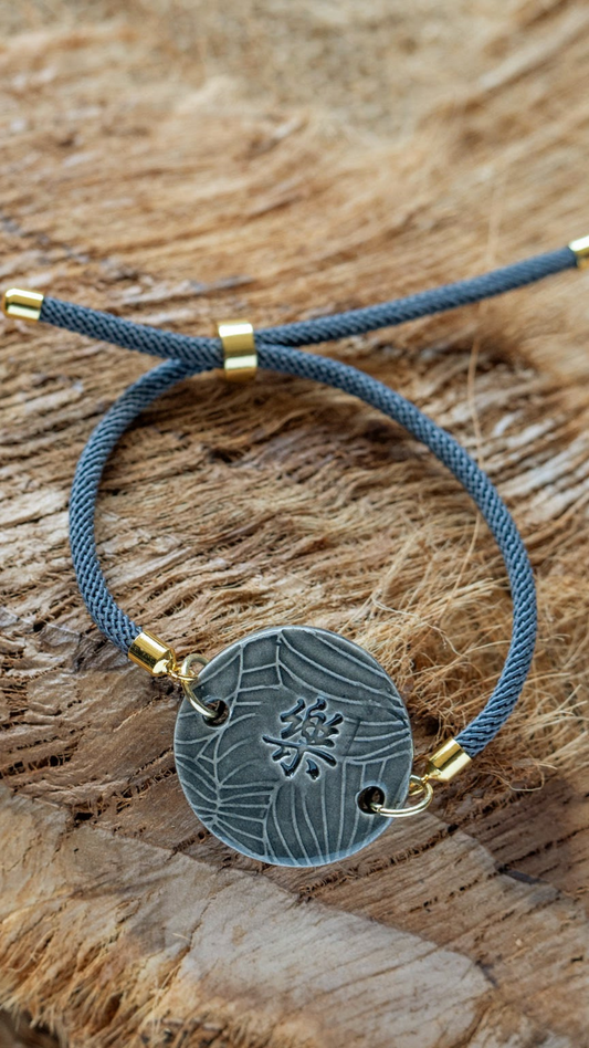 BLT-HAP01GRY: Happiness in Kanji with Monstera Ceramic Bracelet with Adjustable Grey Cable with Gold Tips - Grey glaze