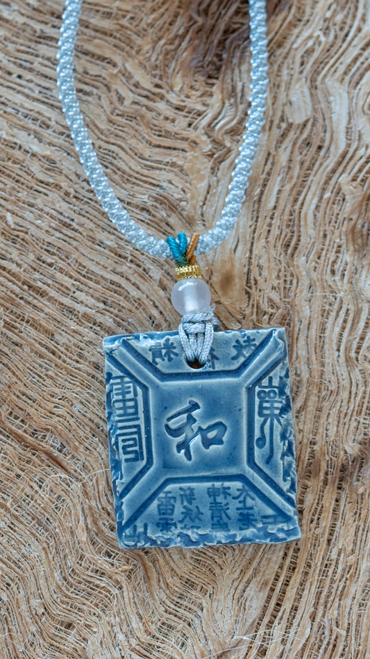 NKL-PCE01BLU: “Peace” Kanji Square Ceramic Necklace – Blue Glaze with Braided Silk Cord