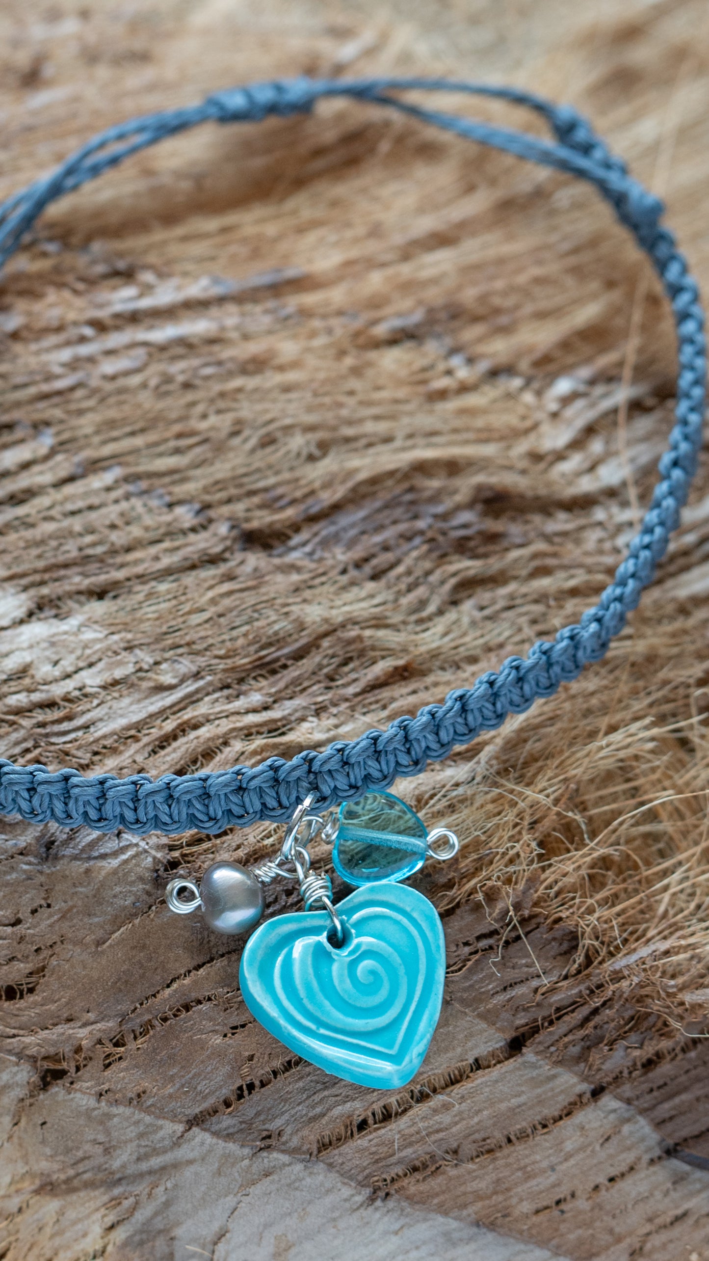 BLT-HRT01AQA: Heart Shaped Ceramic Bracelet – Aqua Glaze with Mini Pearl, Glass Beads & Braided Grey Cord