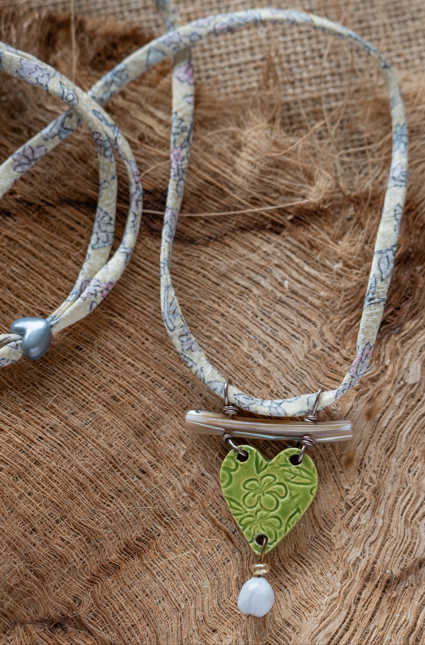 NKL-PLU03GRN: Plumeria Flowers Heart Shaped Ceramic Necklace with Abalone, Job's Tears and Repurposed Silk Kimono Cord – Green Glaze