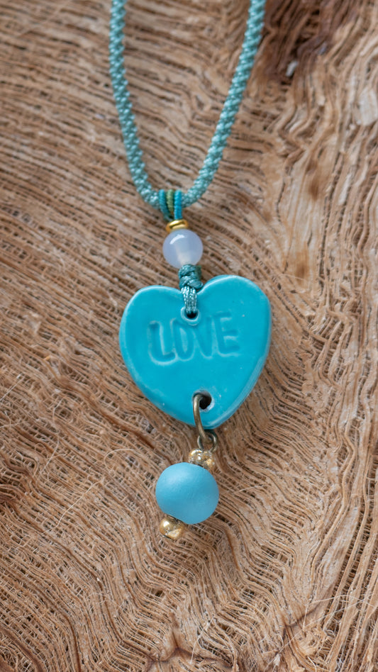 NKL-LOV01AQA: Love Heart Shaped Aqua Ceramic Necklace – Braided Silk Cord