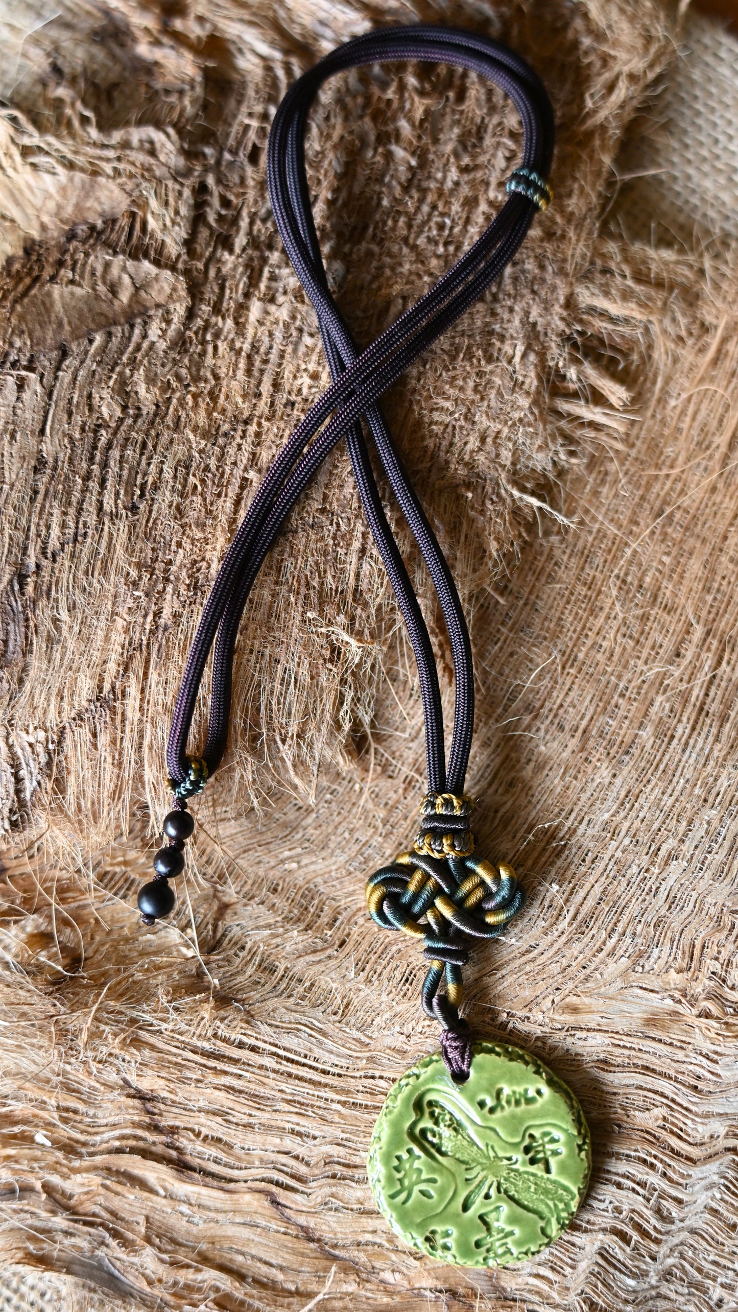 NKL-DRG01GRN: Dragonfly, Courage in Kanji and Love Ceramic Necklace with Celtic weaved cord - Green glaze
