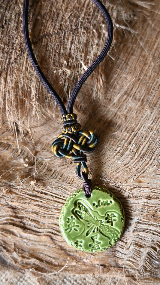 NKL-DRG01GRN: Dragonfly, Courage in Kanji and Love Ceramic Necklace with Celtic weaved cord - Green glaze